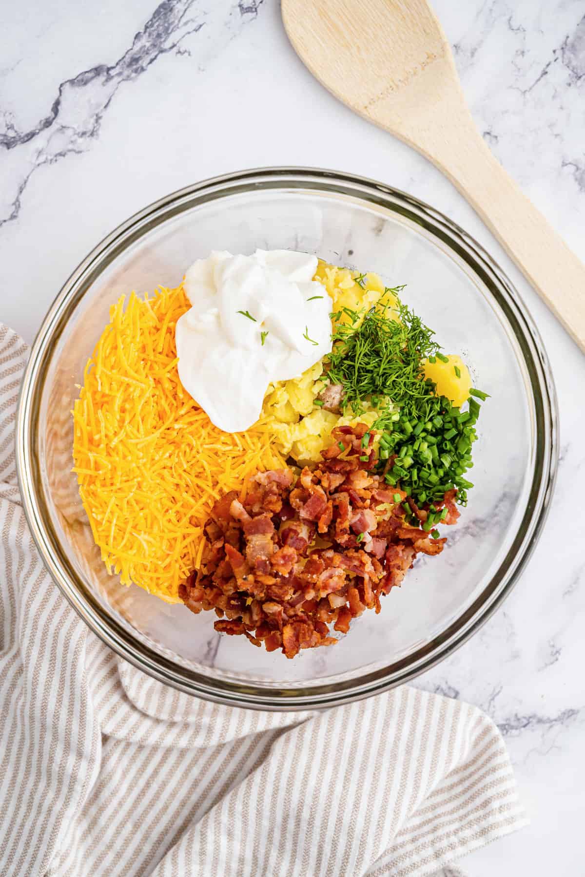 Adding fixings to mashed potates for Mini Twice Baked Potatoes