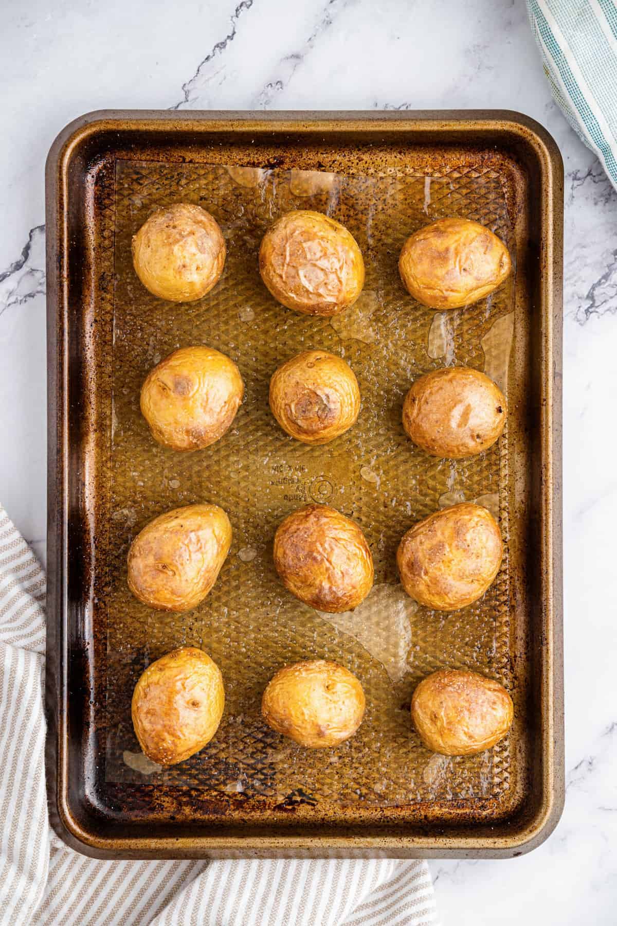 Baked potatoes on baking sheet for Mini Twice Baked Potatoes
