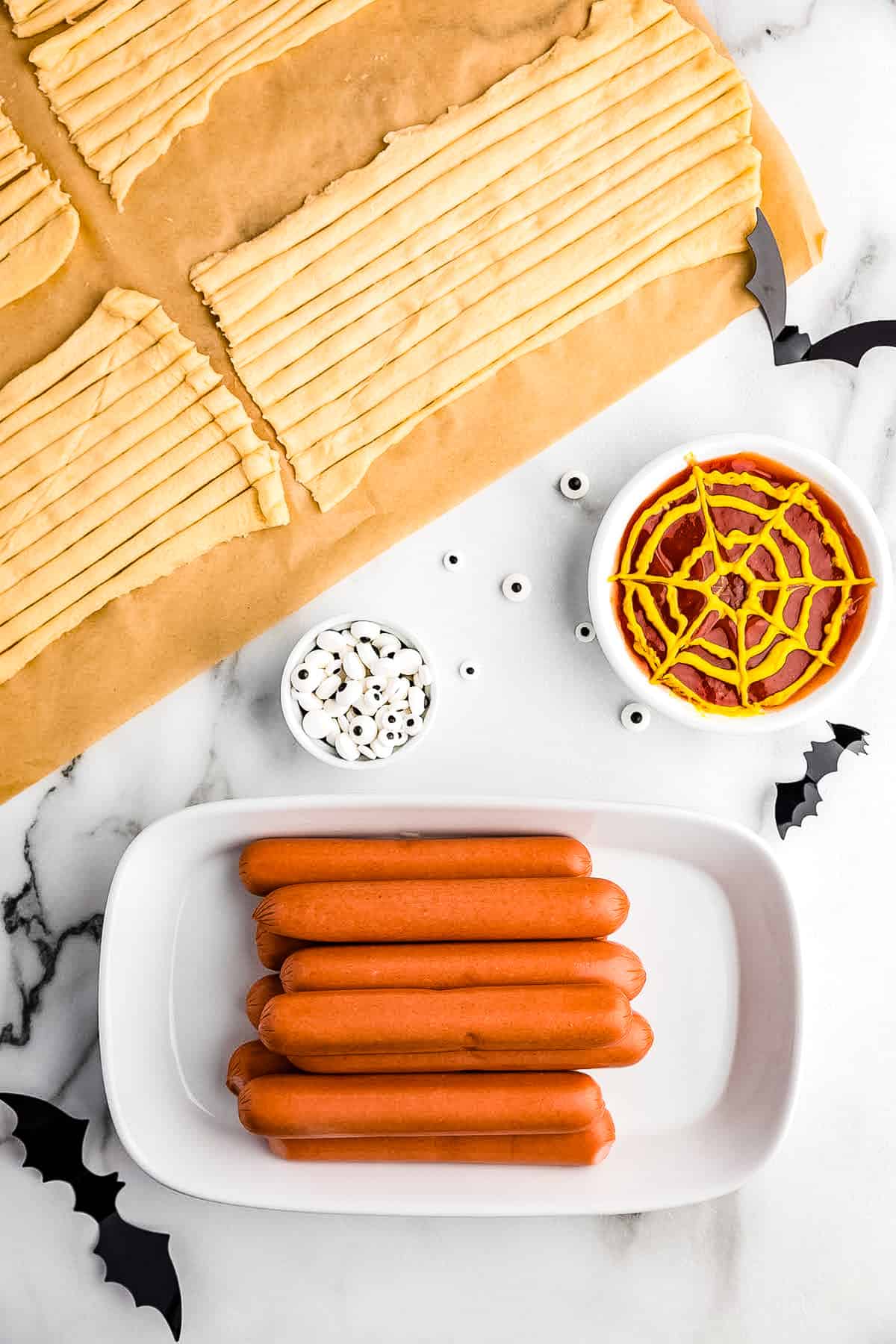 Unroll all of the crescent roll portions and lay flat. Cut with a knife 10 strips lengthwise.