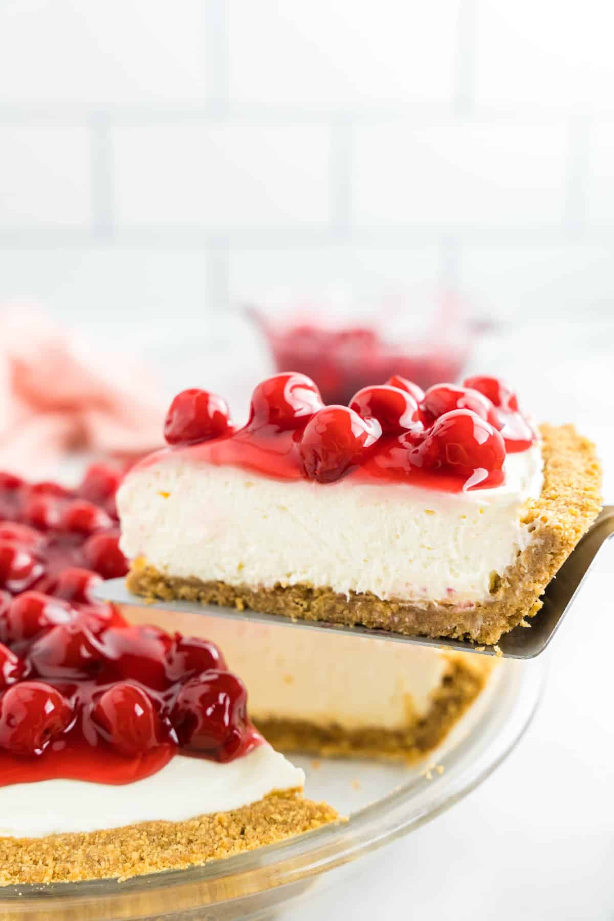 Easy No Bake Cheesecake Sliced and Ready to for the First Bite