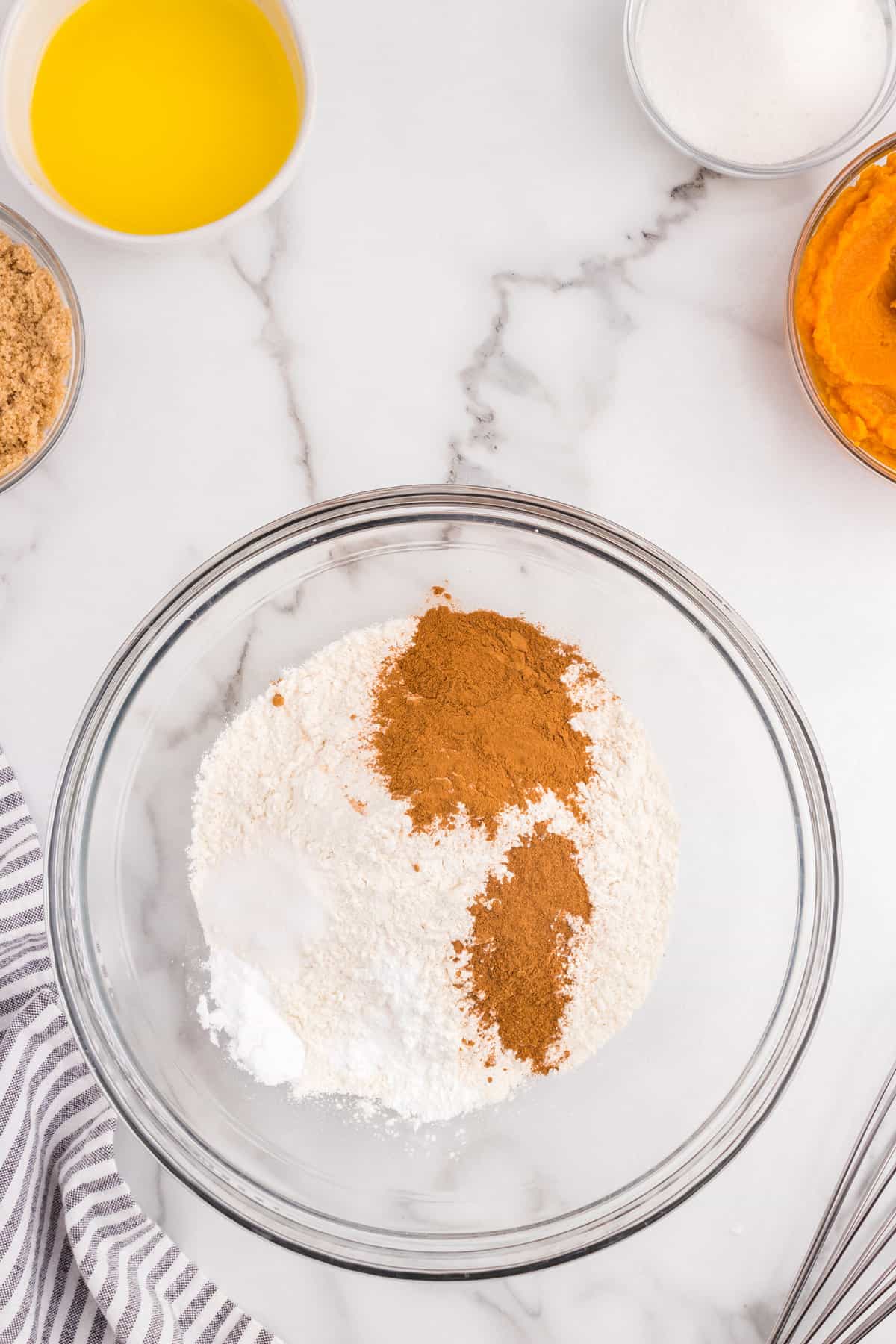 Combining dry ingredients in mixing bowl for Pumpkin Donuts recipe