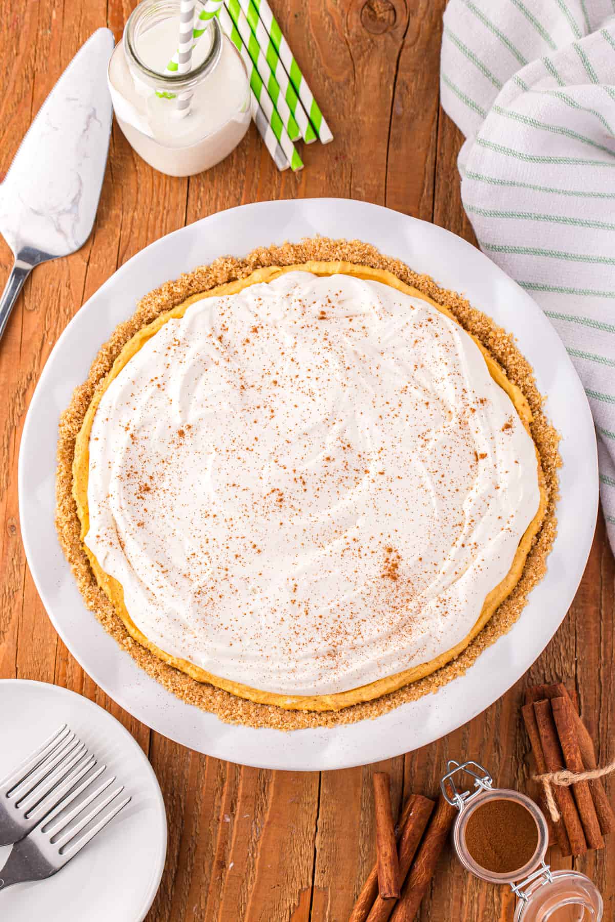 Adding whipped cream and spices for garnish to Pumpkin Mousse Pie recipe