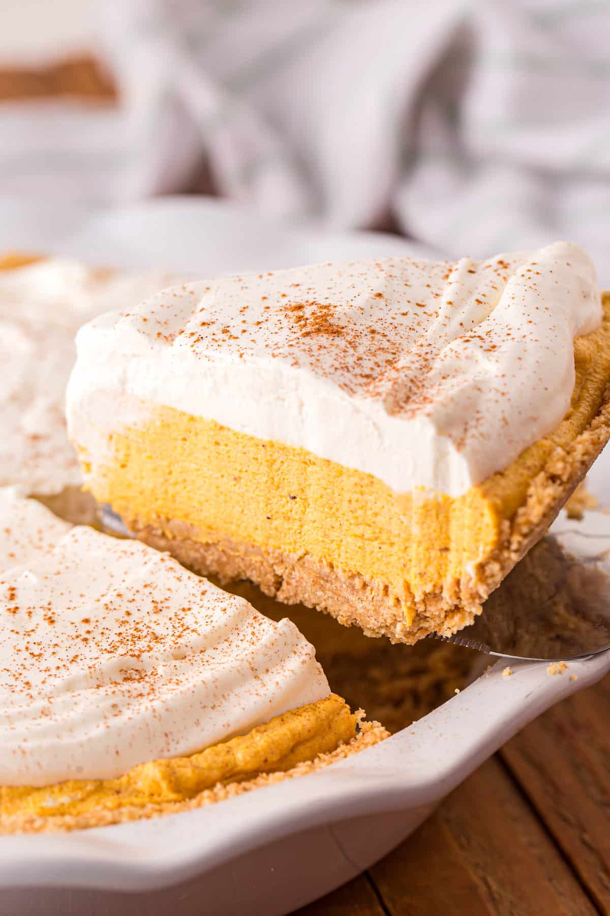 Removing one slice of Pumpkin Mousse Pie from cut pie with spatula