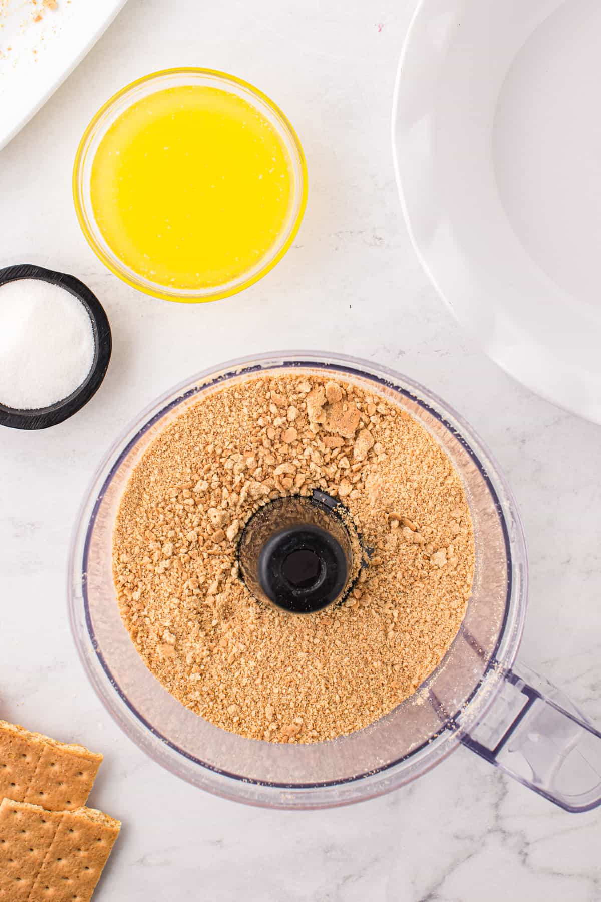 Using a food processor to grind graham cracker sheets for Pumpkin Mousse Pie recipe