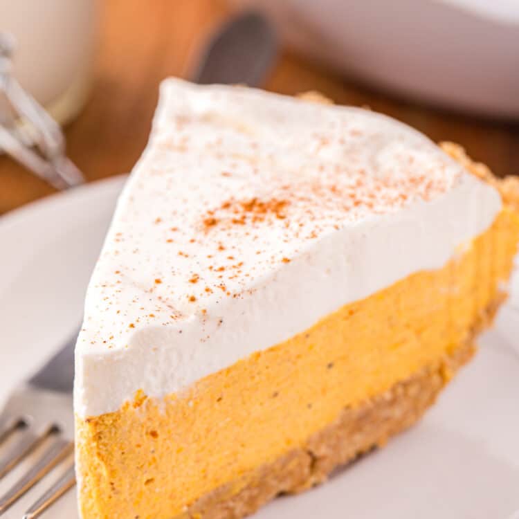 Slice of Pumpkin Mousse Pie on white plate with fork