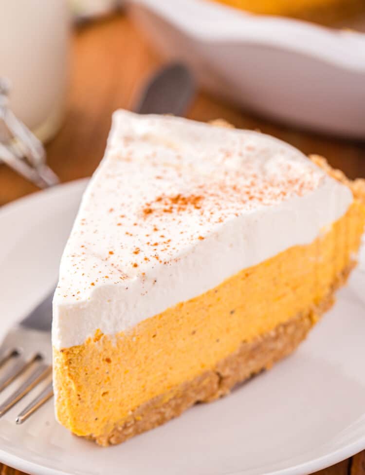 Slice of Pumpkin Mousse Pie on white plate with fork
