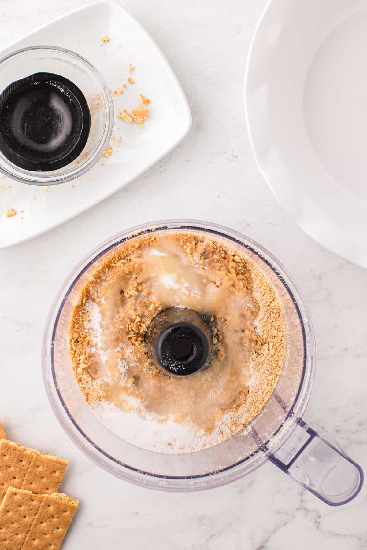 Adding sugars and metled butter to graham cracker mixture for Pumpkin Mousse Pie crust