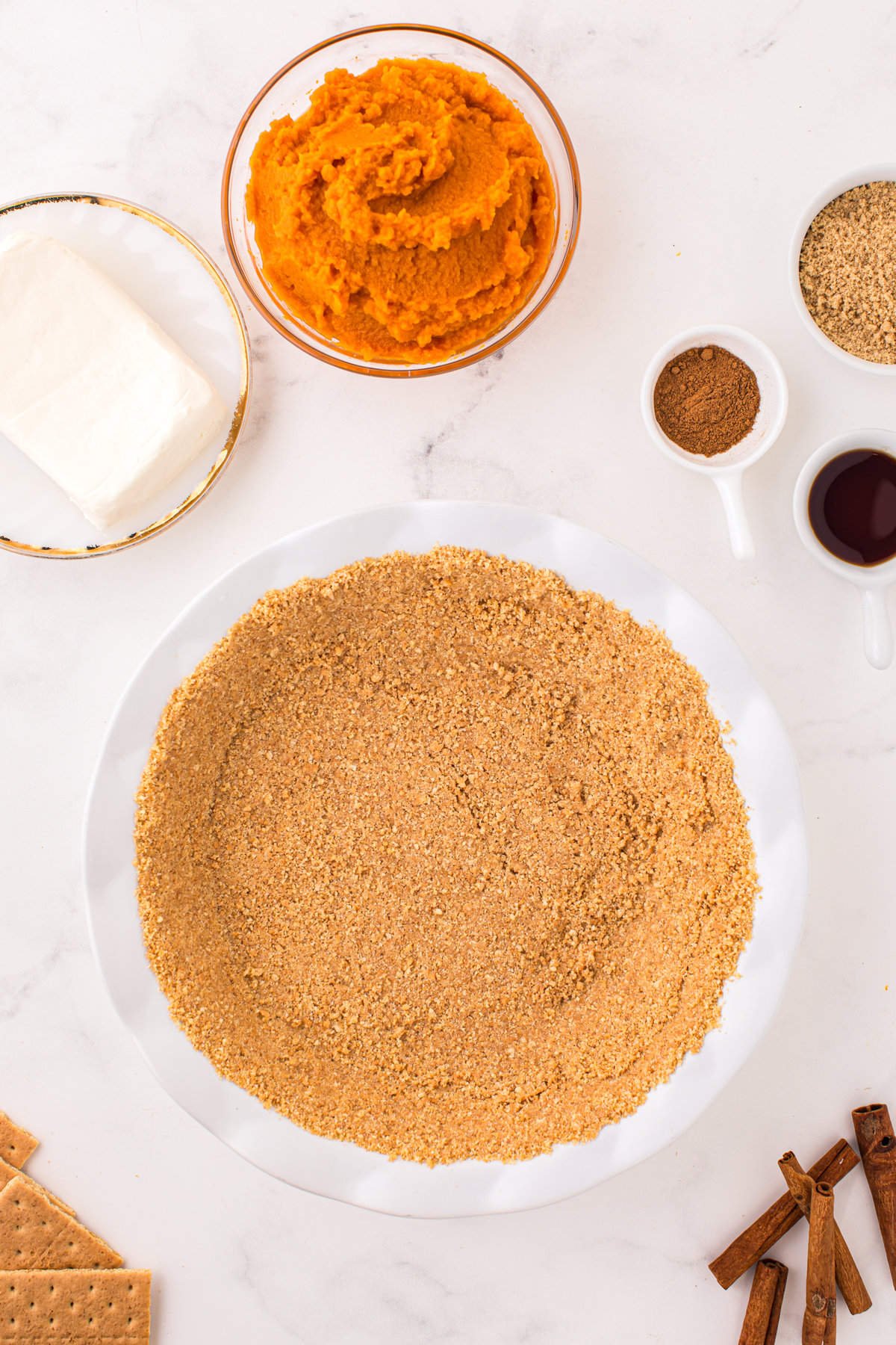 Firmly pressing graham cracker crust for Pumpkin Mousse Pie into pie pan