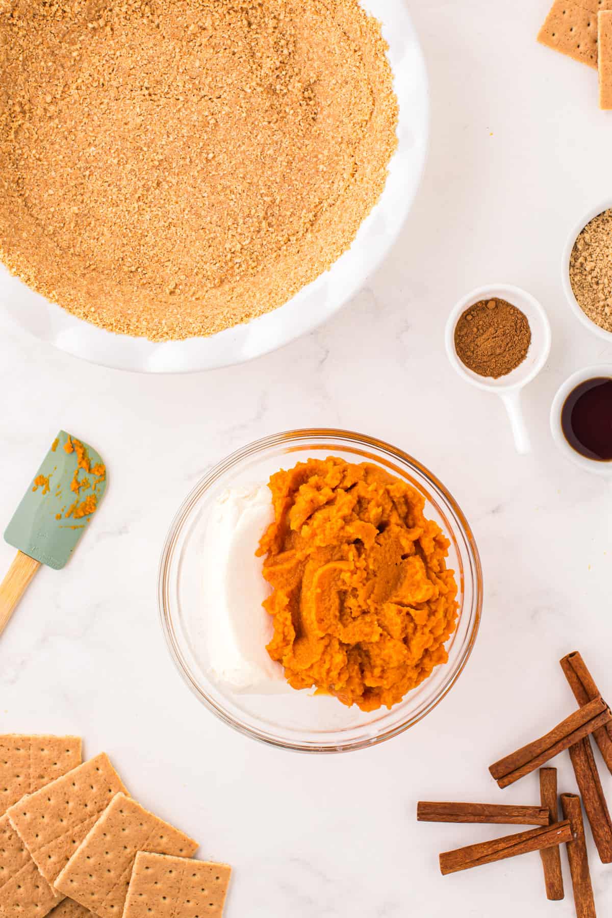 Pumpkin puree and cream cheese in mixing bowl for Pumpkin Mousse Pie recipe