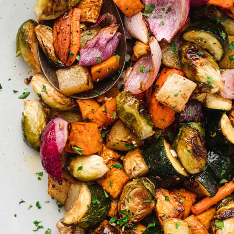 Oven Roasted Vegetables in serving dish with serving spoon