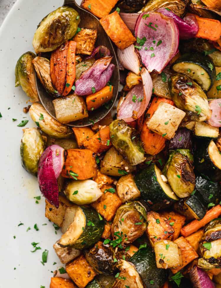 Oven Roasted Vegetables in serving dish with serving spoon