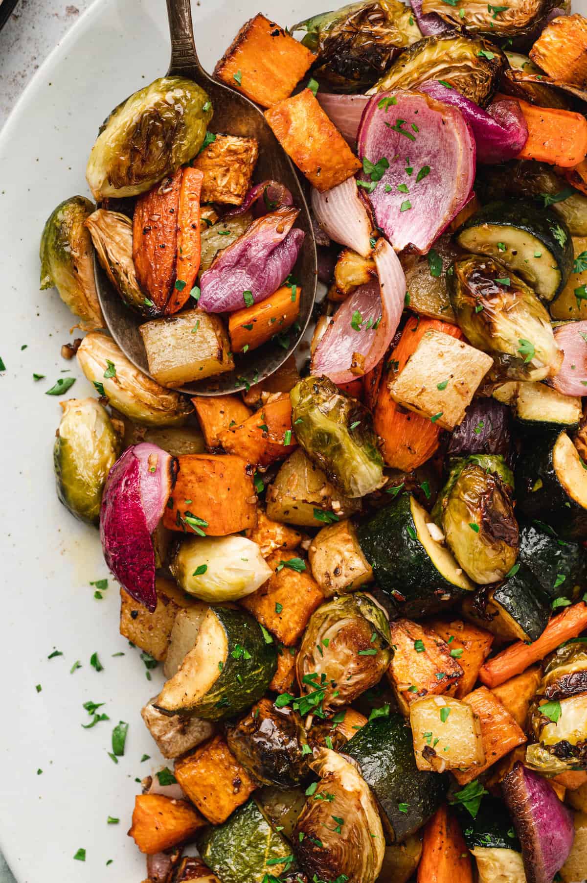 Oven Roasted Vegetables in serving dish with serving spoon