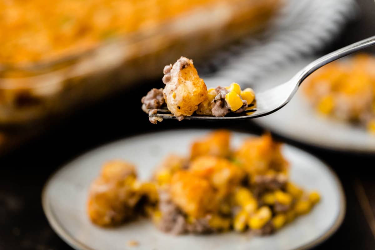Tater Tot Casserole on plate with forkful of the first bite