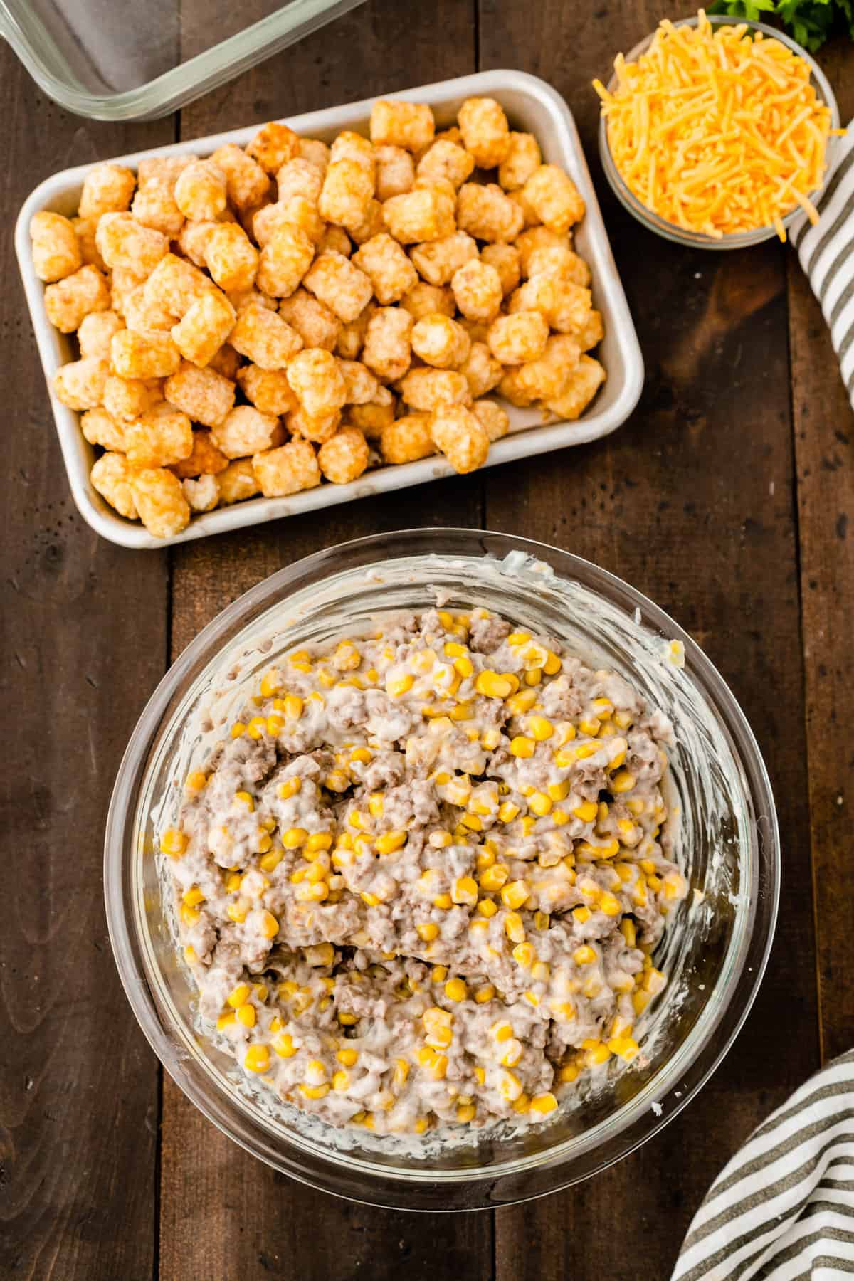 Completing the ground beef mixture of condensed cream of mushroom soup for Tator Tot Casserole