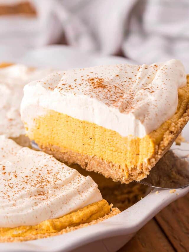 Removing one slice of Pumpkin Mousse Pie from cut pie with spatula