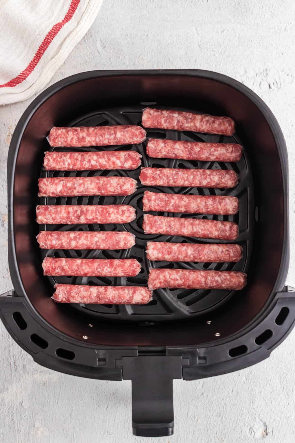 Uncooked Breakfast Sausage in Air Fryer well spaced