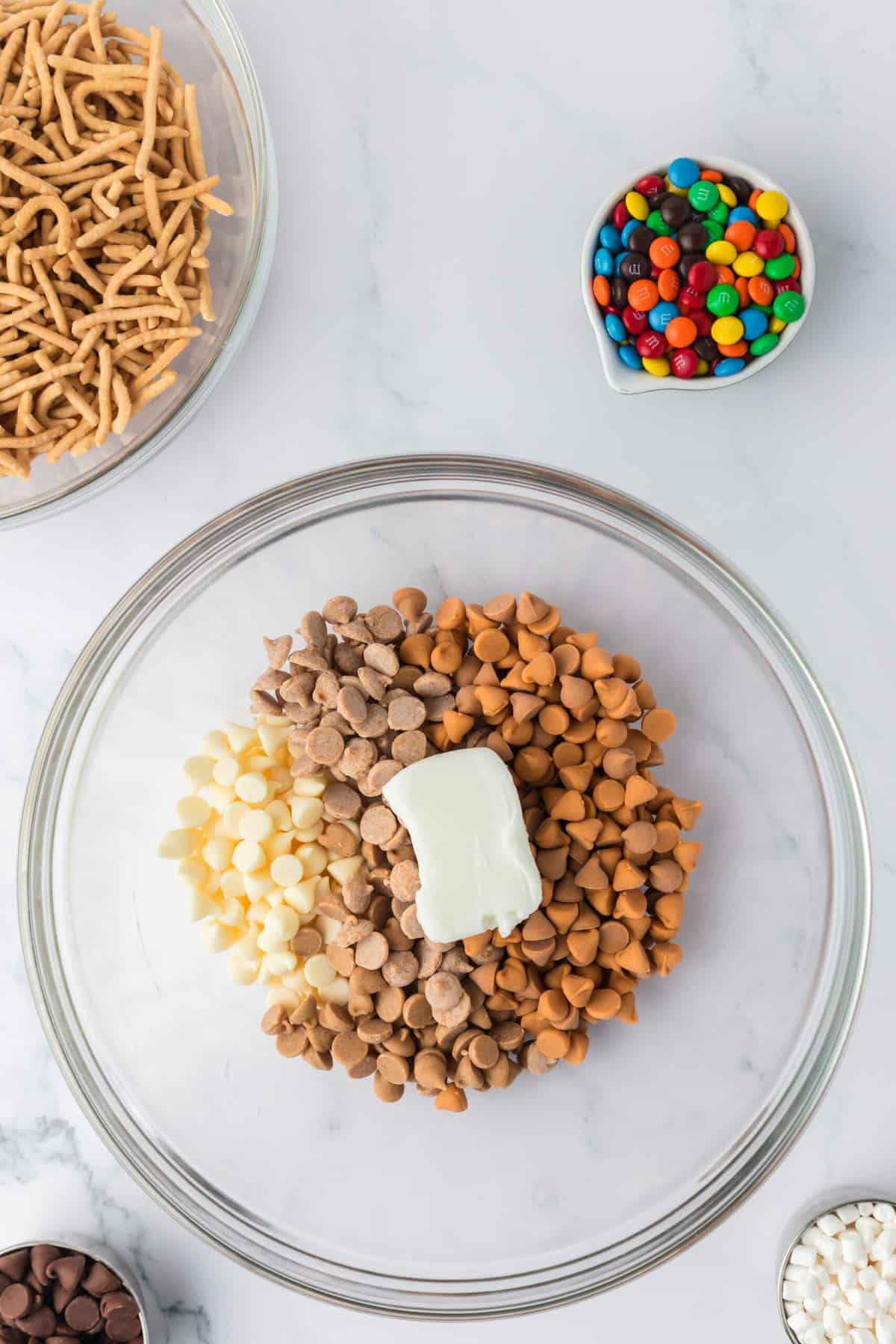 Put butterscotch, peanut butter, white chocolate chips and shortening into a microwave safe bowl and melt while stirirng often.