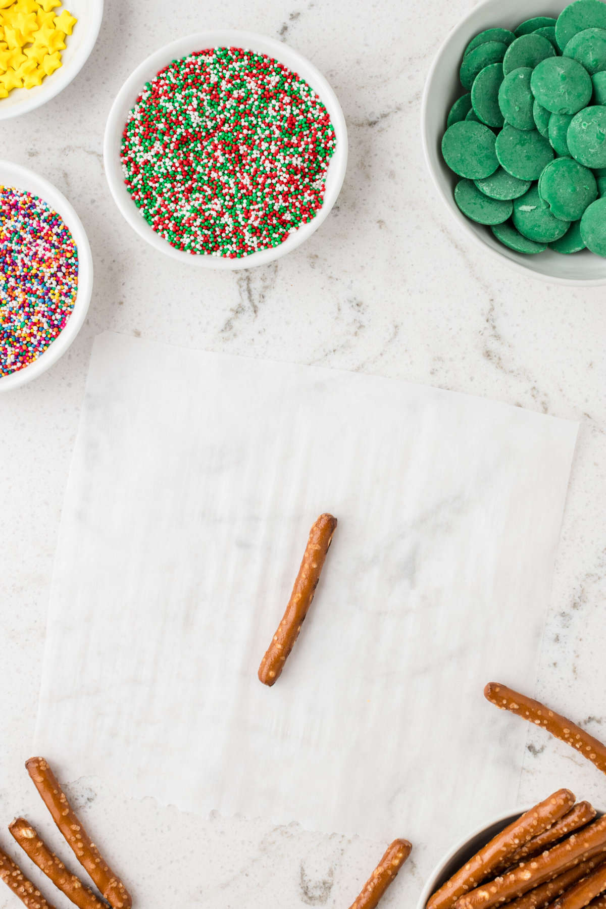 Place pretzel sticks on parchment paper