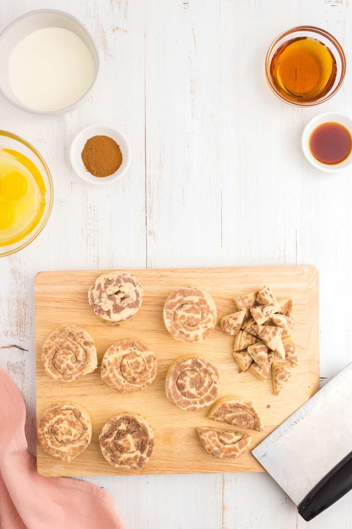 Placing Pillsbury Cinnamon Roll discs on cutting board and cutting into pieces for Cinnamon Roll Casserole recipe