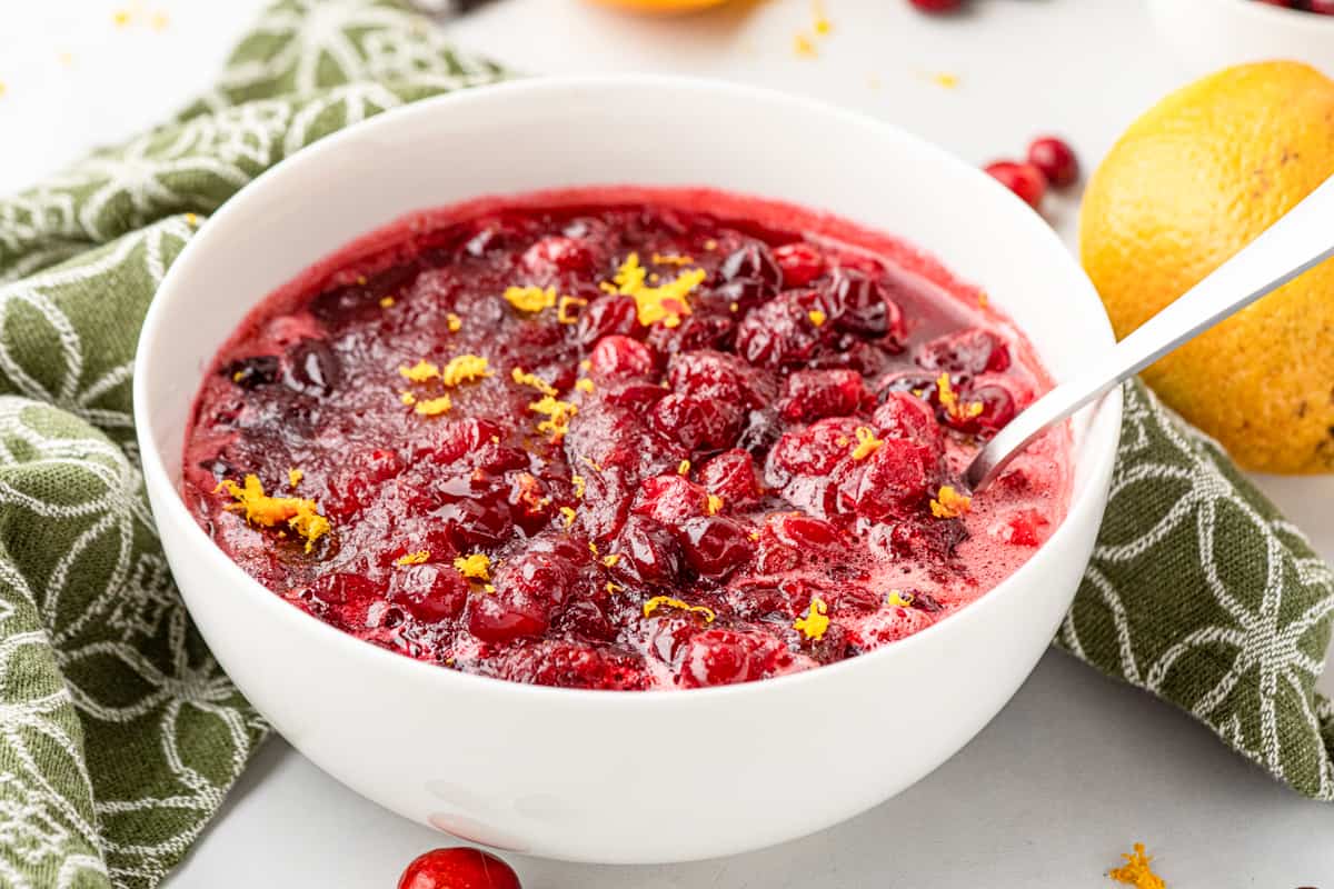 White bowl with cranberry sauce and spoon