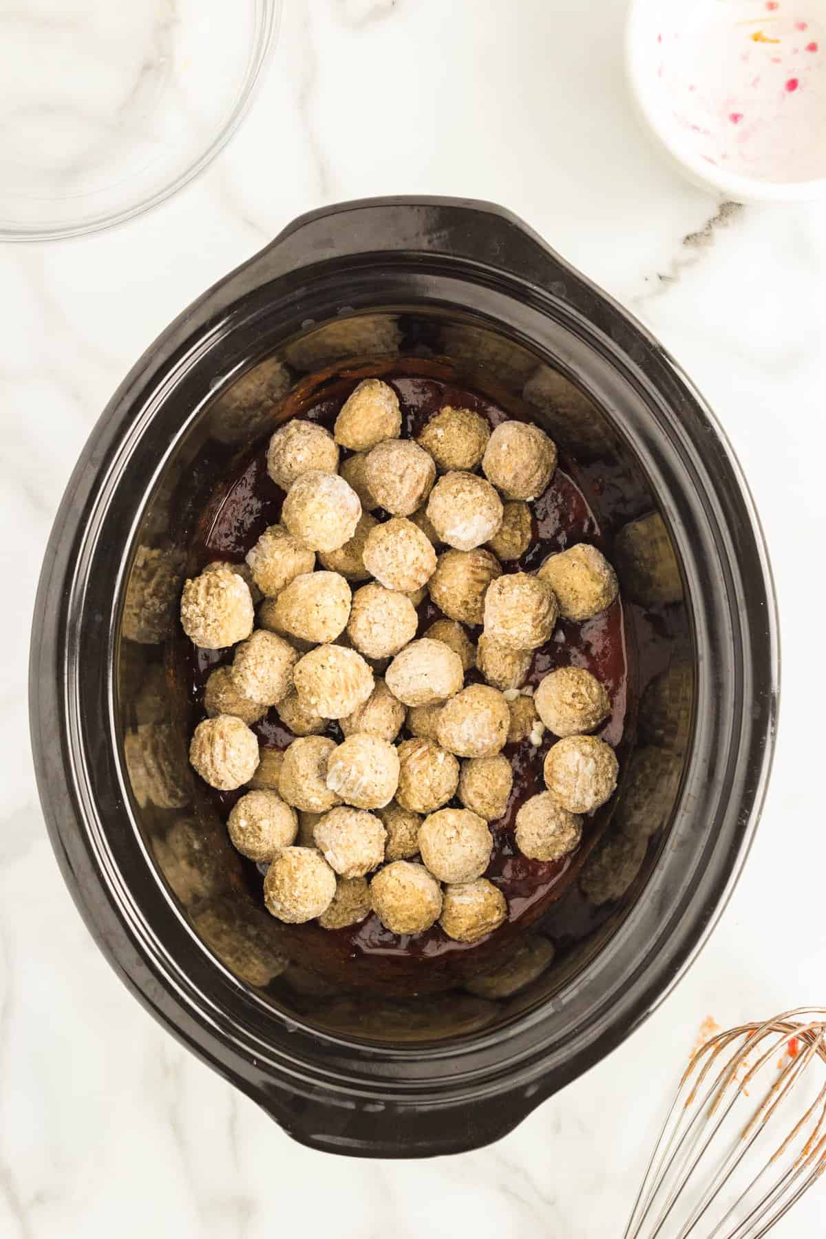 Adding frozen meatballs to jelly and chili suace for Grape Jelly Meatballs