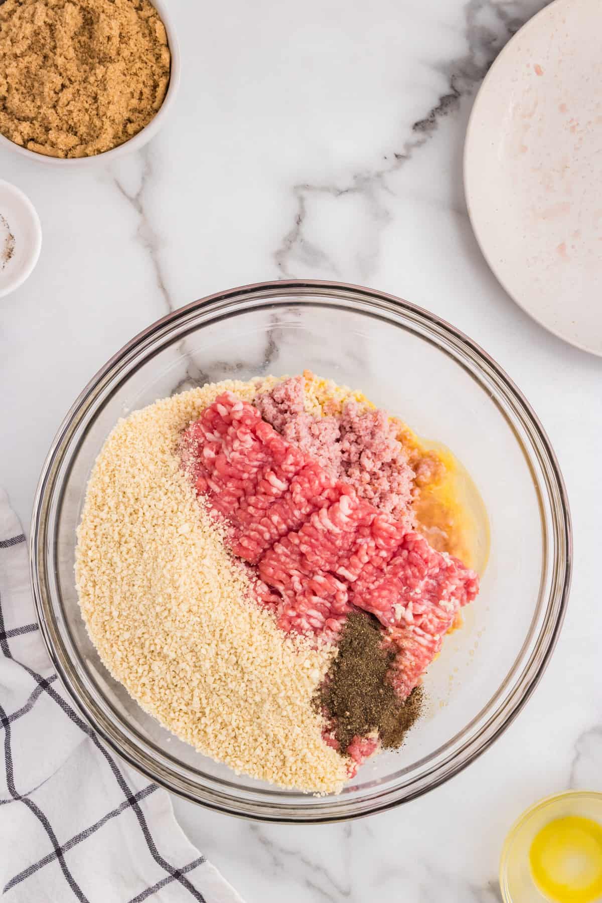 Mixing ingredients for Ham Balls recipe in a glass mixing bowl