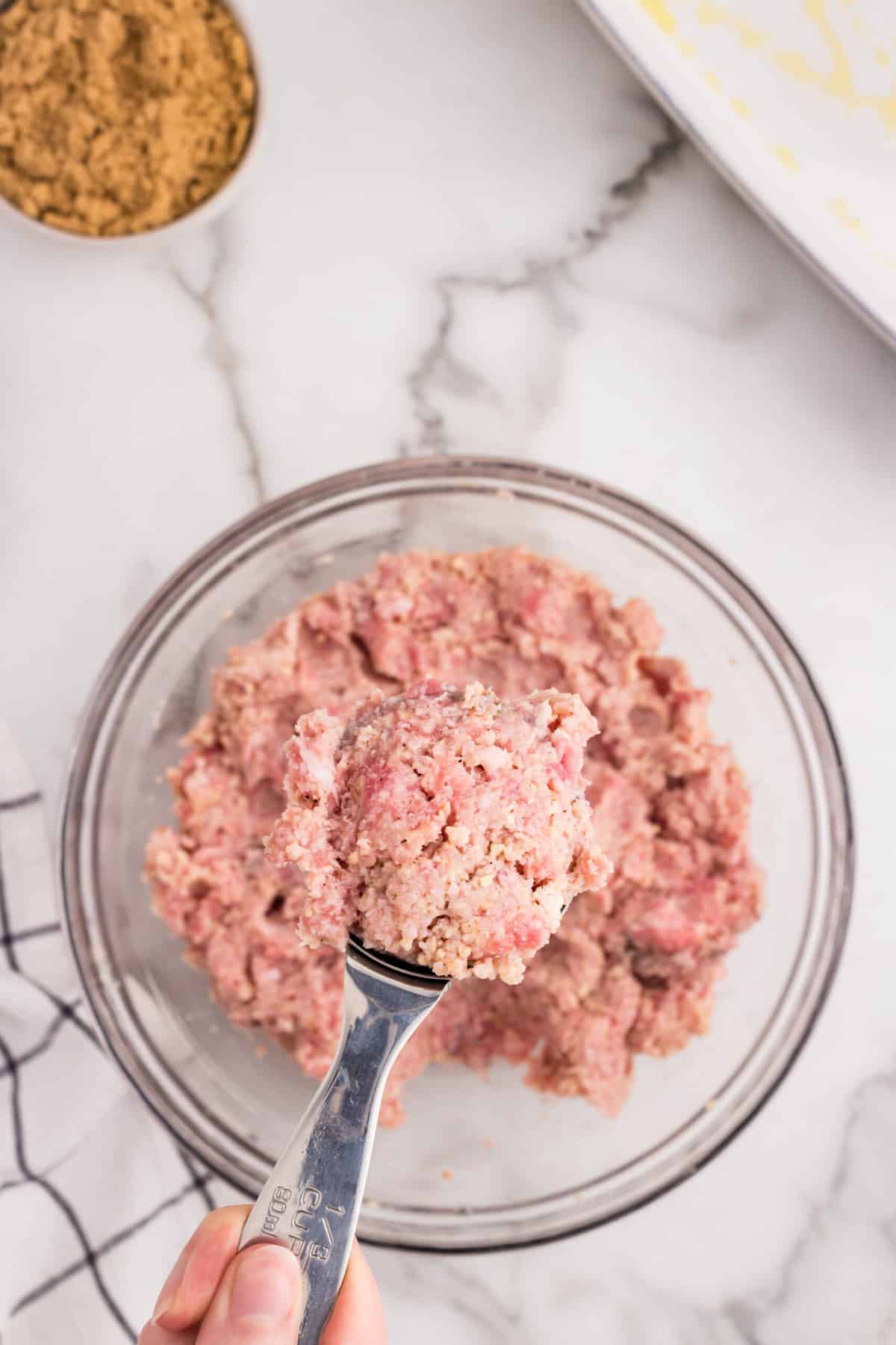 Loosing scooping combined ham ball mixture with scooper for Ham Balls recipe