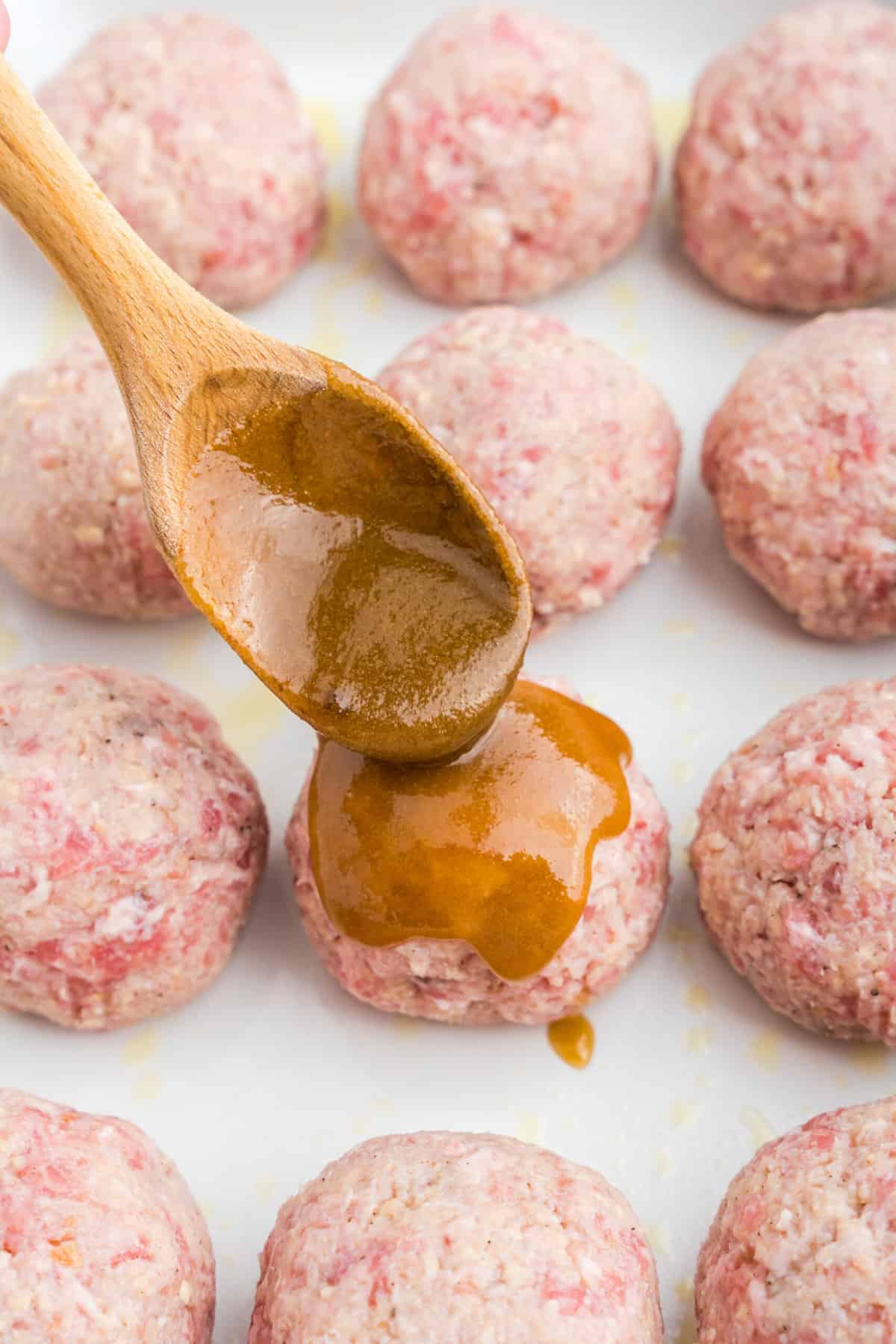 Spooning glaze  onto Ham Balls 