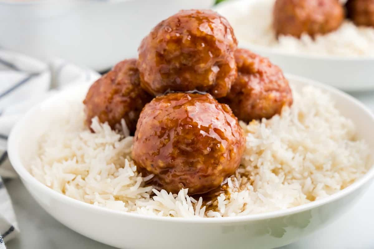 Ham balls on a bed of rice in a serving bowl