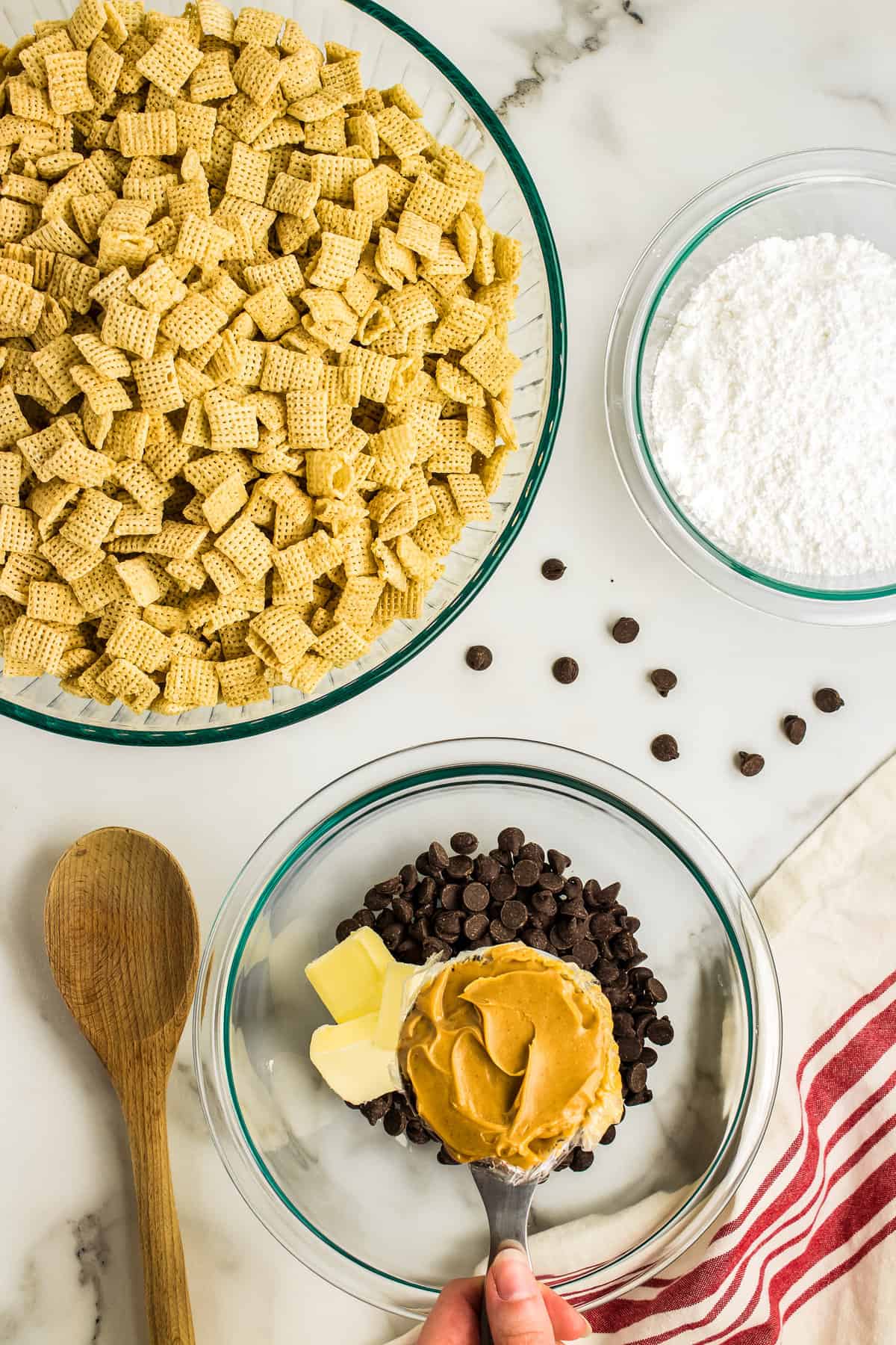 Add peanut butter to the chocolate chips and butter and melt slowly, stirring often.