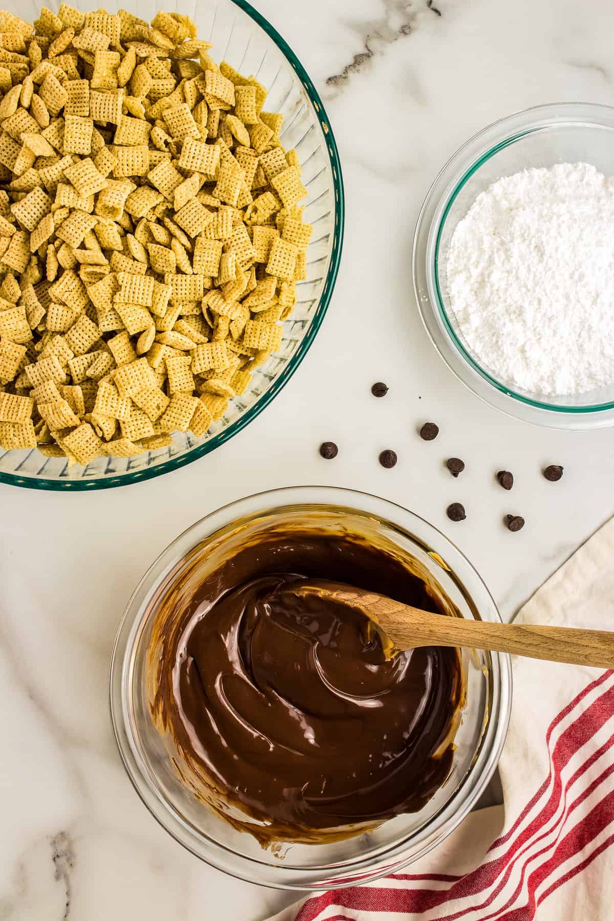 Melting and stirring peanut butter, chocolate & butter until there are no chunks.