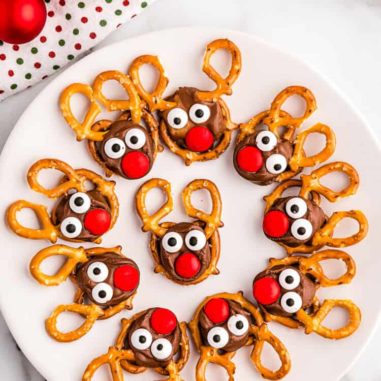 White Plate full of Reindeer Pretzels laying in a Circle.