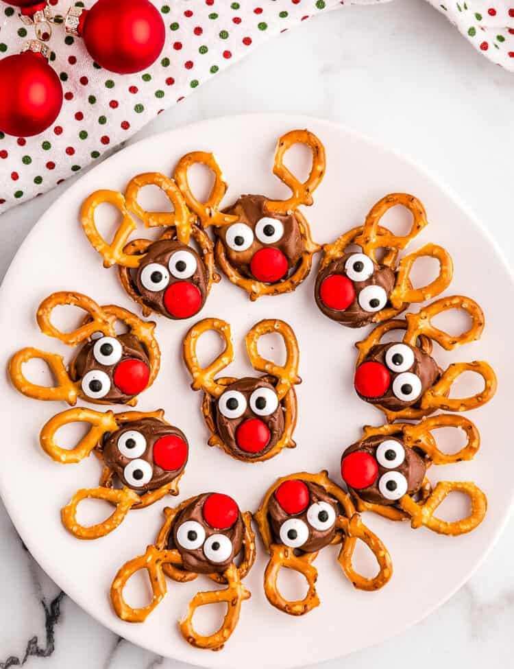 White Plate full of Reindeer Pretzels laying in a Circle.