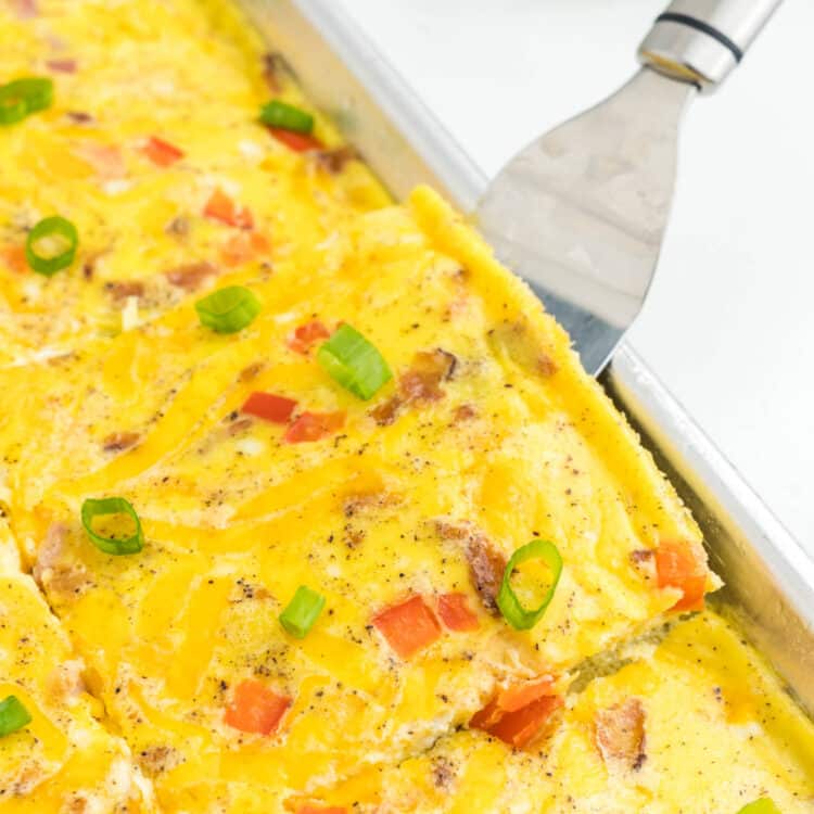 Sheet Pan Eggs cut into square in shallow baking pans with metal spatula