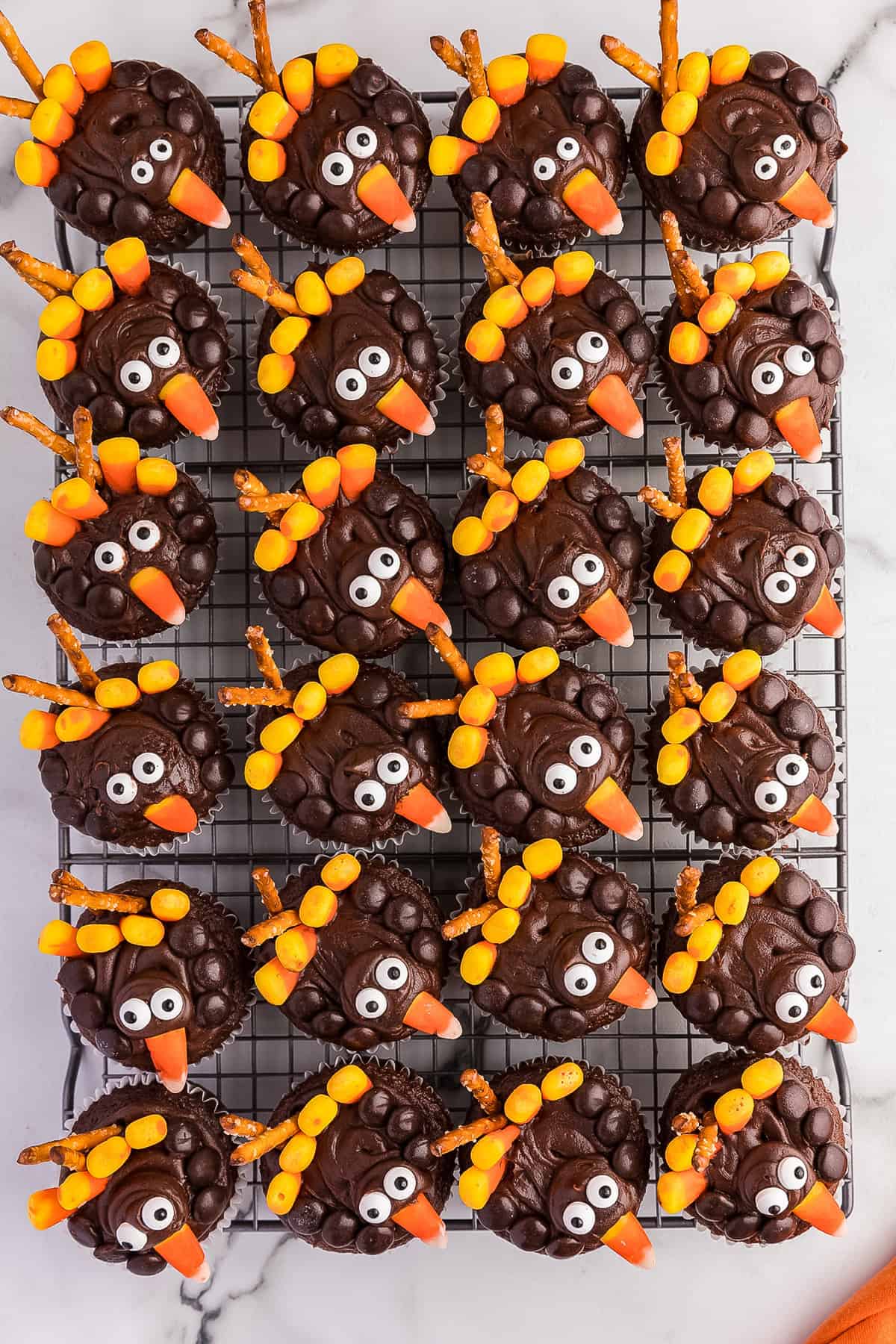 Overview photo of a bunch of turkey cupcakes completed. Looks like a bunch of turkeys looking up at you.