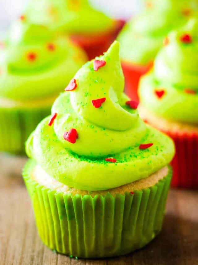 Close up photo of a completed grinch cupcake with cupcakes in the background.