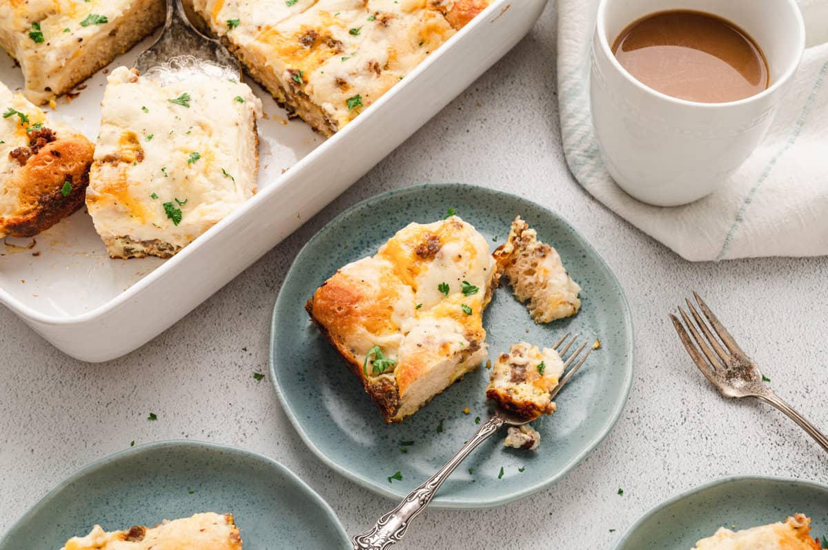 Bicuits & Gravy Casserole cut into square piece on plate with one bite taken