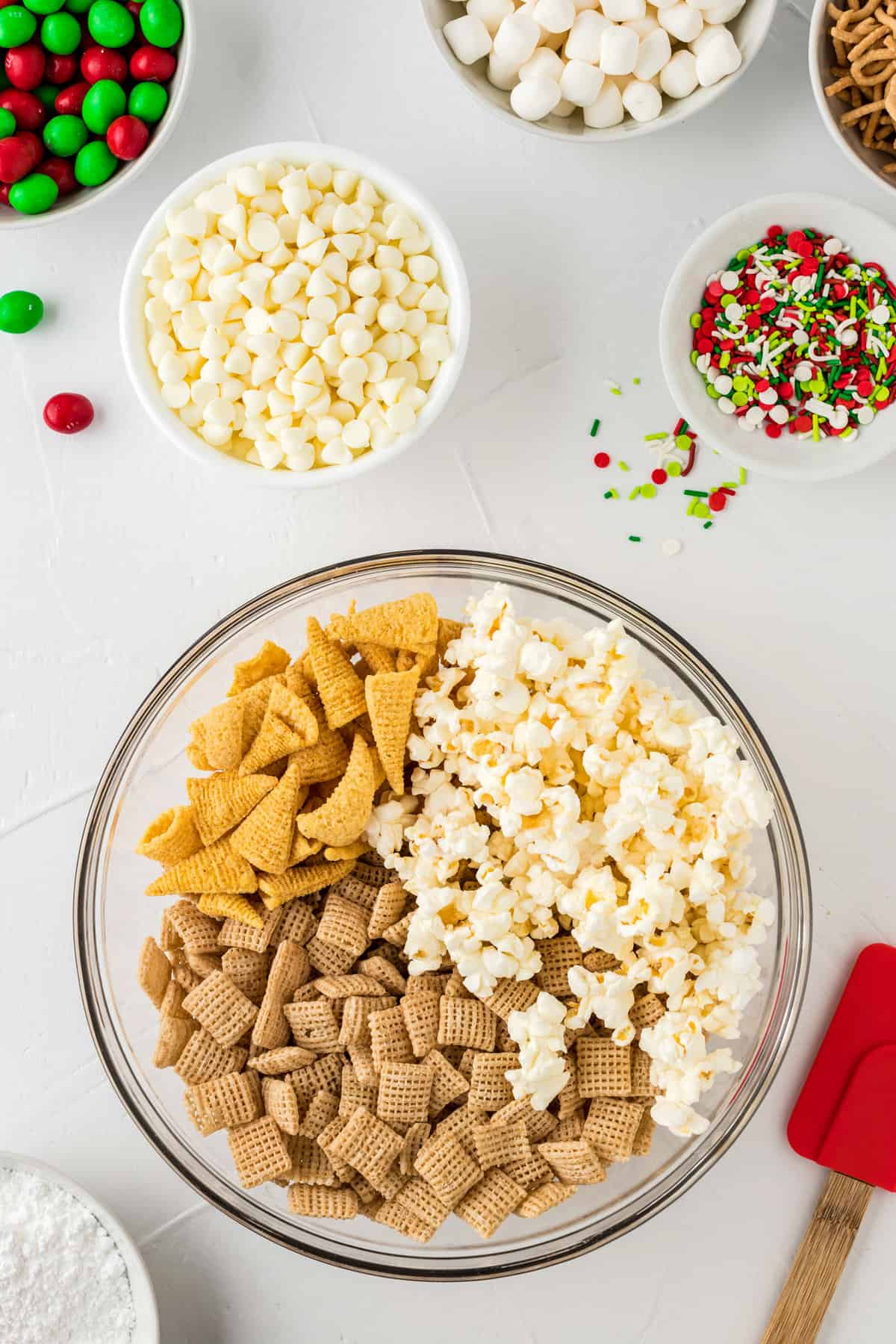 In a Large bowl mix together Popcorn, bugles & rice Chex and set aside.