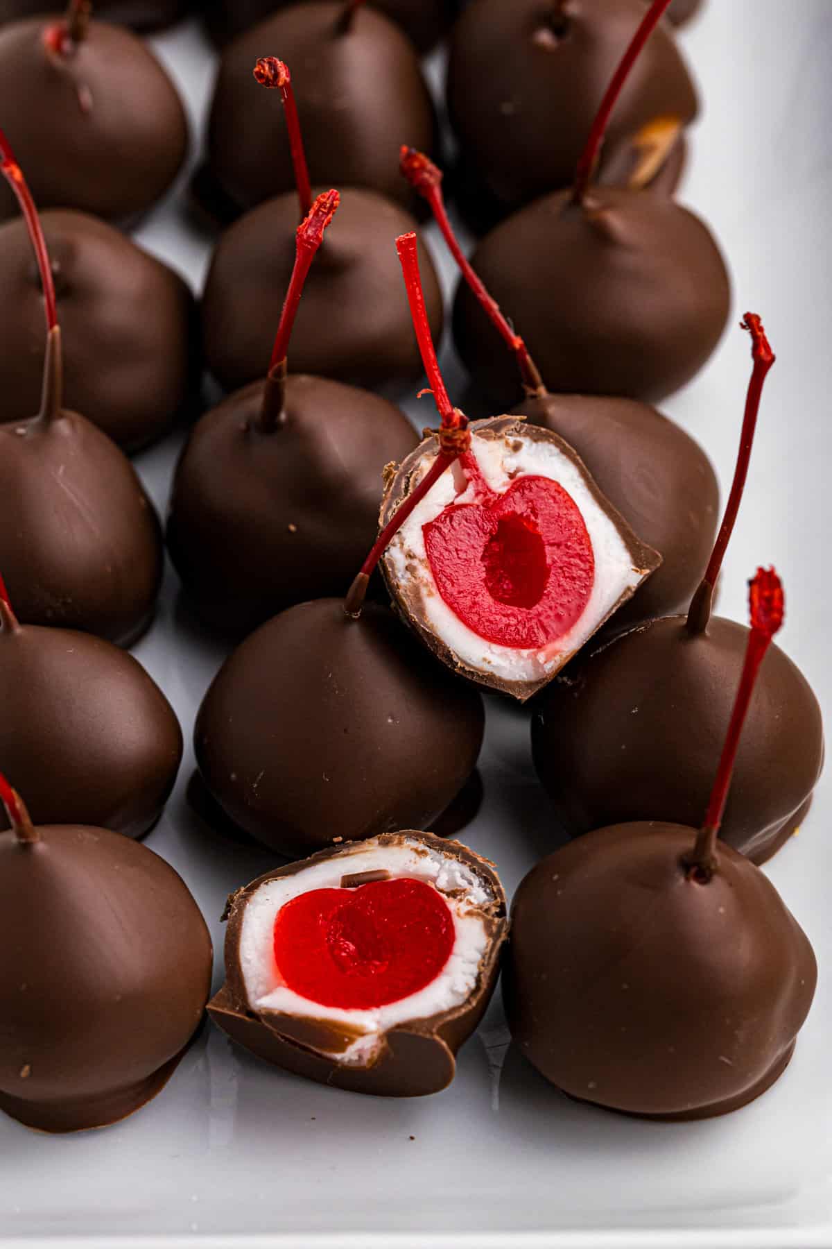 Chocolate Covered Cherries sliced over lined on a serving tray