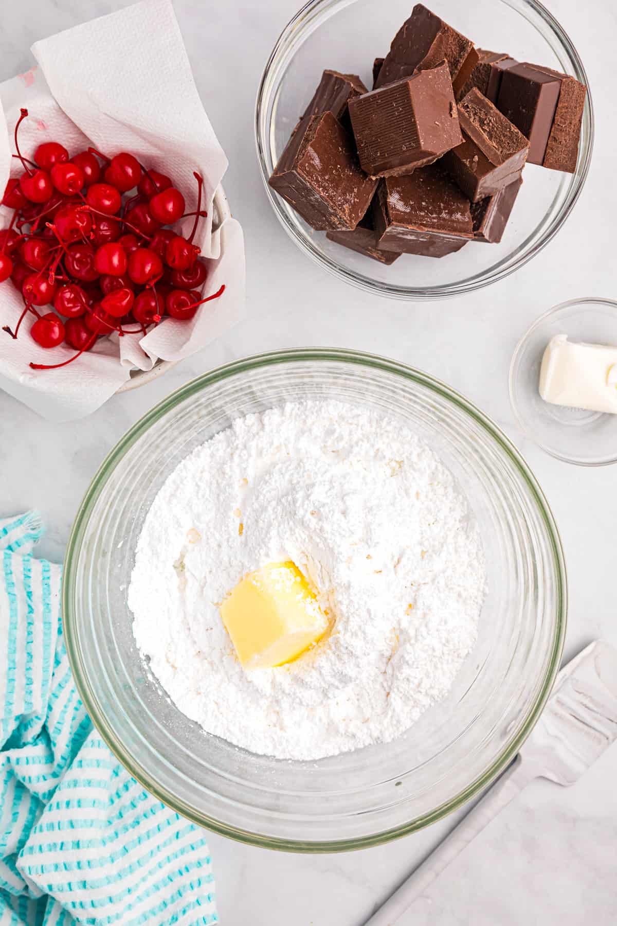 Creaming together butter and sugar in a glass mixing bowl for Chocolate Covered Cherries recipe