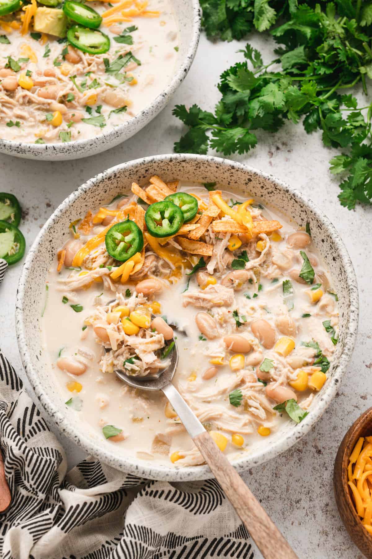 Crock Pot White Chicken Chili in bowl with added fixings