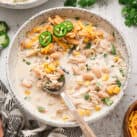 Overhead Square Image of Crock Pot White Chicken Chili in bowl with spoon
