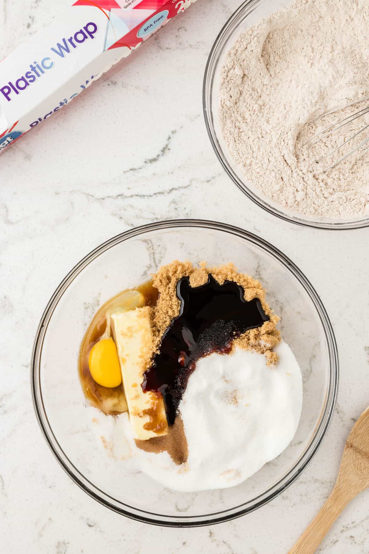 In a different large bowl, cream together butter, brown sugar, sugar, molasses, egg and vanilla extract.