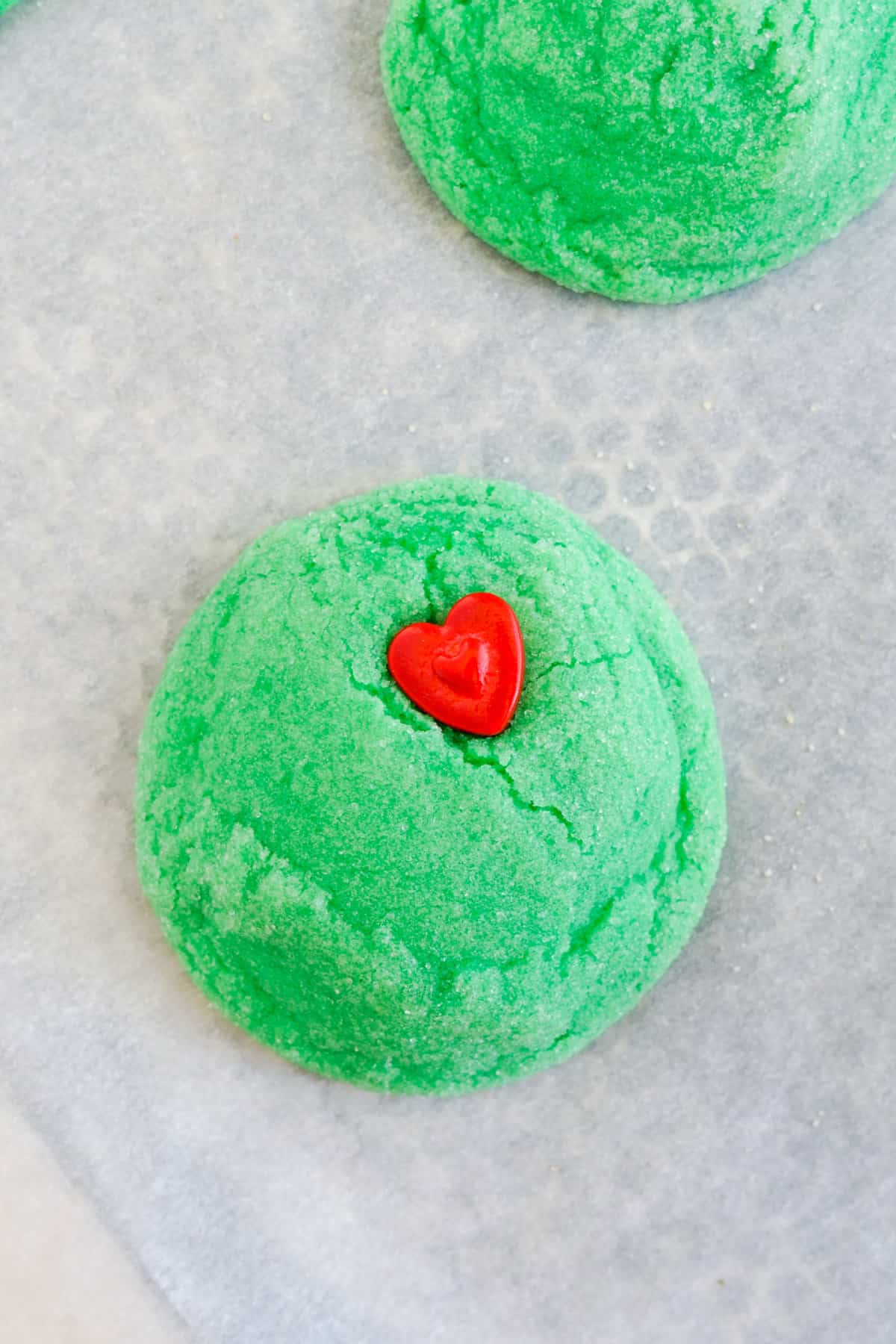 Bake cookies for about 8-9 minutes and takeout when they're just starting to brown. Place a little heart on each of the cookies.