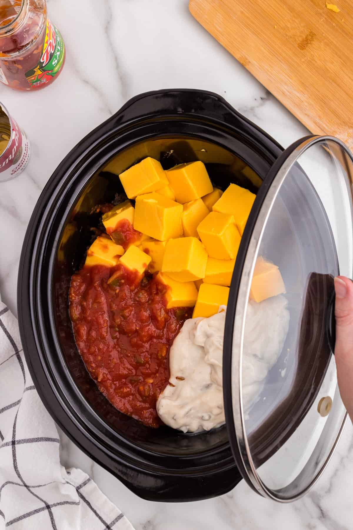 Covering crock pot with lid for Hamburger Cheese Dip recipe