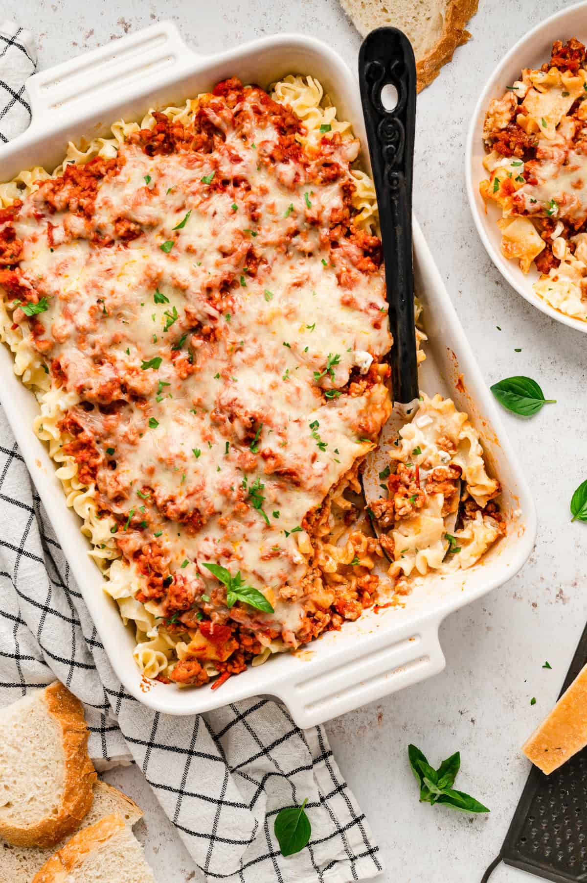 Lasagna Casserole hot out of the oven in a baking dish with serving spoon