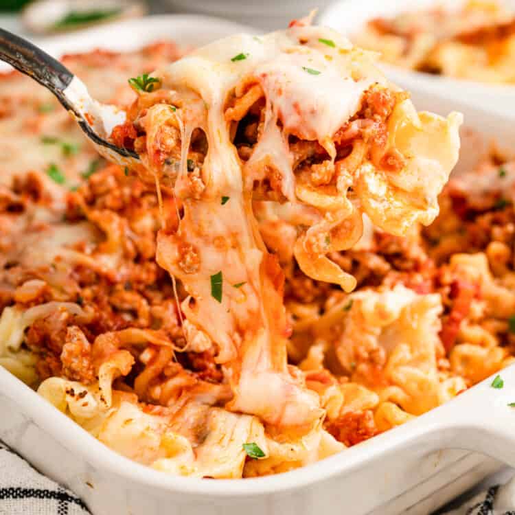 Scooping Lasagna Casserole from baking dish