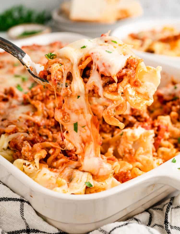 Scooping Lasagna Casserole from baking dish