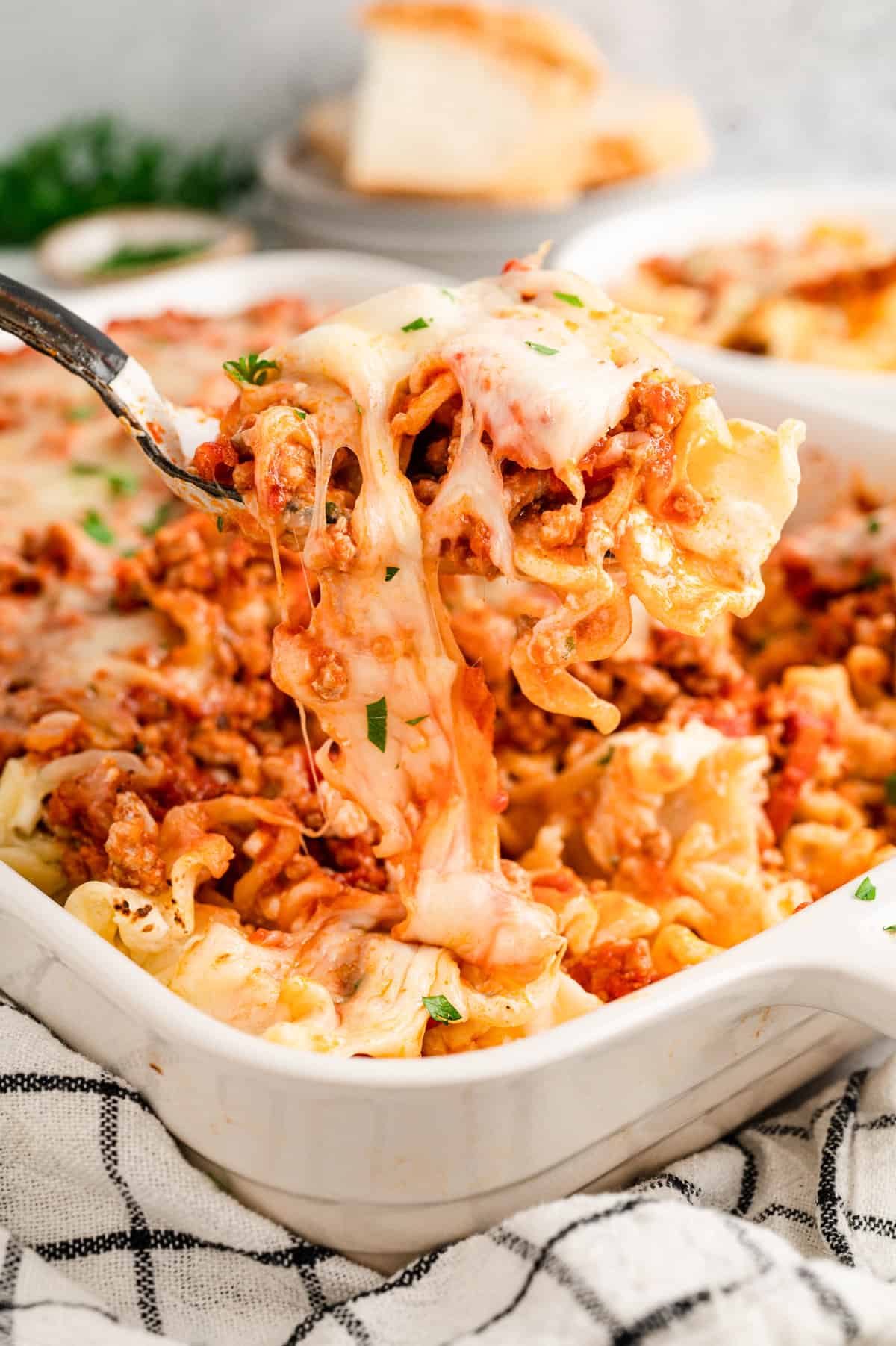 Scooping Lasagna Casserole from baking dish