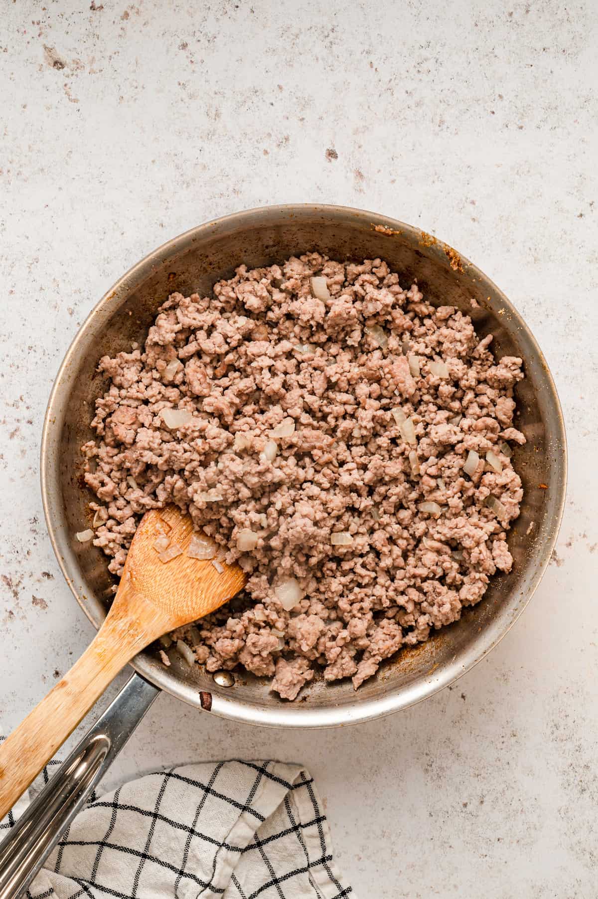 Browning pork sausage in stovetop skillet for Lasagna Casserole recipe